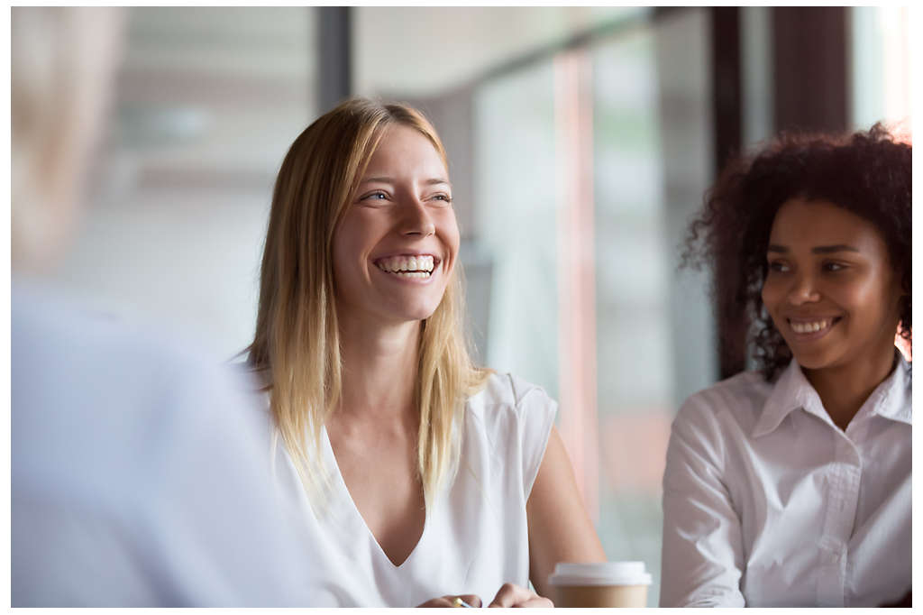 A woman smiling with her colleagues