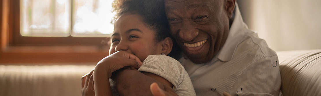 Grandfather hugging his granddaughter