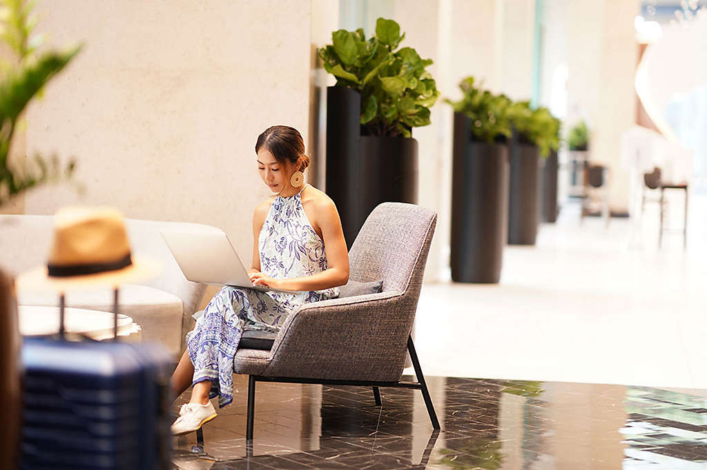 woman sitting and researching insurance on her laptop