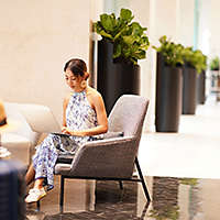 woman sitting and researching insurance on her laptop