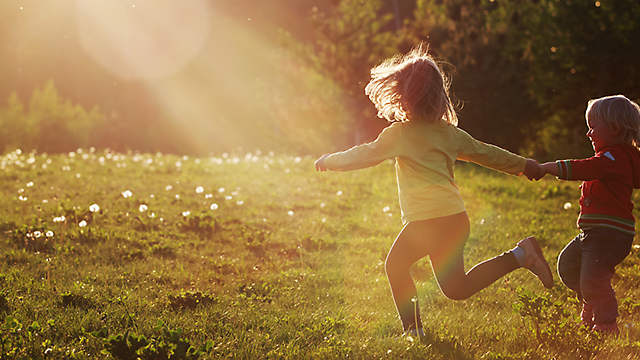 Kids running in the grass