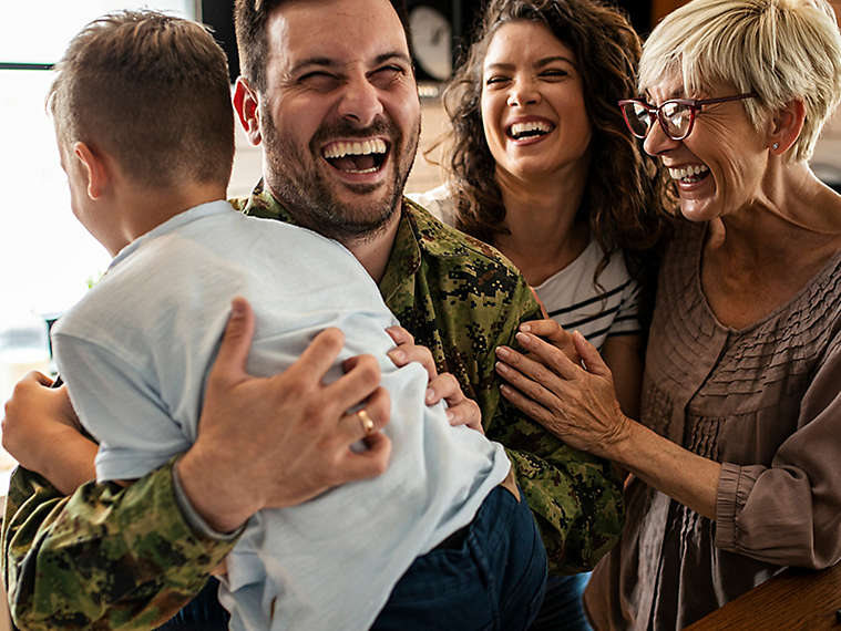 Family laughing together in their kitchen