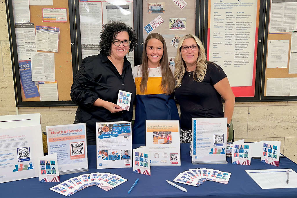 New York Life’s Yvonne Baez-Last, Jeanette Liberto, and Christine Pisciotta with a variety of activities for employees to participate in during Month of Service.