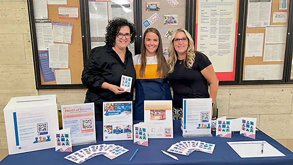 New York Life’s Yvonne Baez-Last, Jeanette Liberto, and Christine Pisciotta with a variety of activities for employees to participate in during Month of Service.