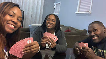 Office Coordinator Kenya Stewart playing cards.