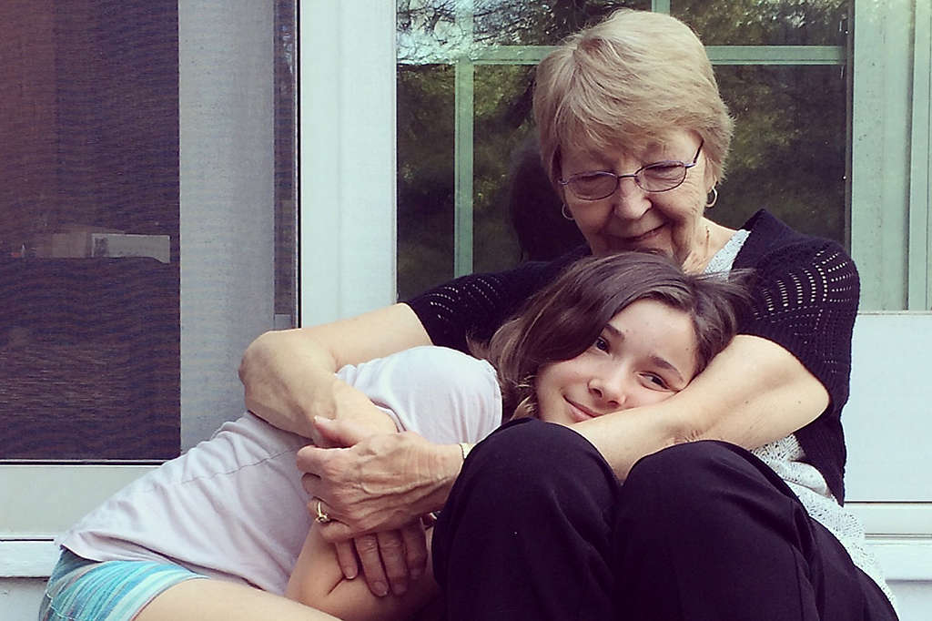 Grandmother and granddaughter hugging