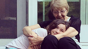 Grandmother and granddaughter hugging