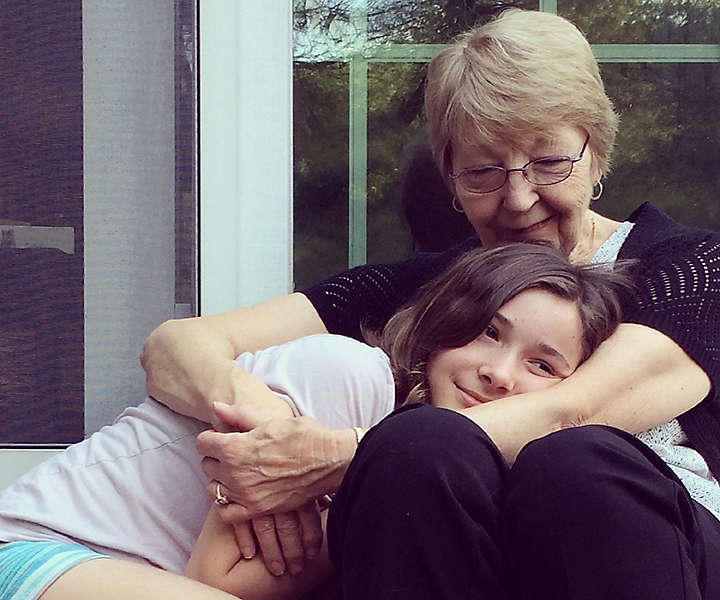 Grandmother and granddaughter hugging
