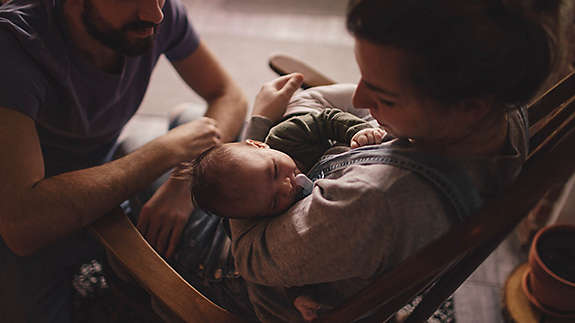 Young couple holding their baby