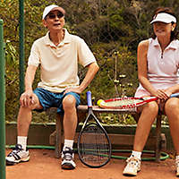 Older couple playing tennis