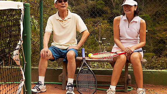 Older couple playing tennis