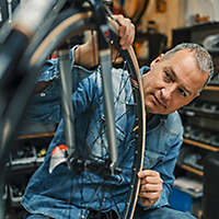 A man working on a bicycle in a repair shop