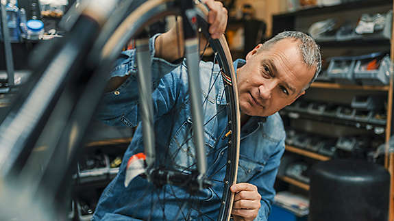 A man working on a bicycle in a repair shop