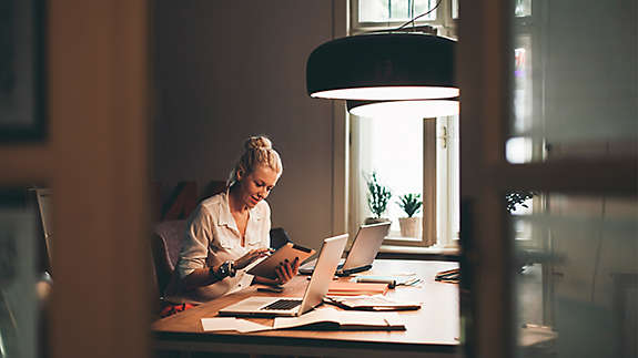 Woman working at table in kitchen