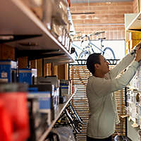 Salesman searching for box on store shelves