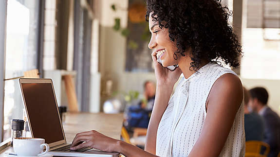 Woman sitting at a counter working on her laptop