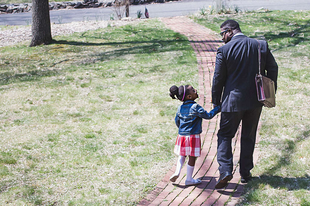 father and daughter leave the house holding hands