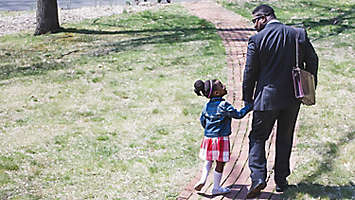 father and daughter leave the house holding hands