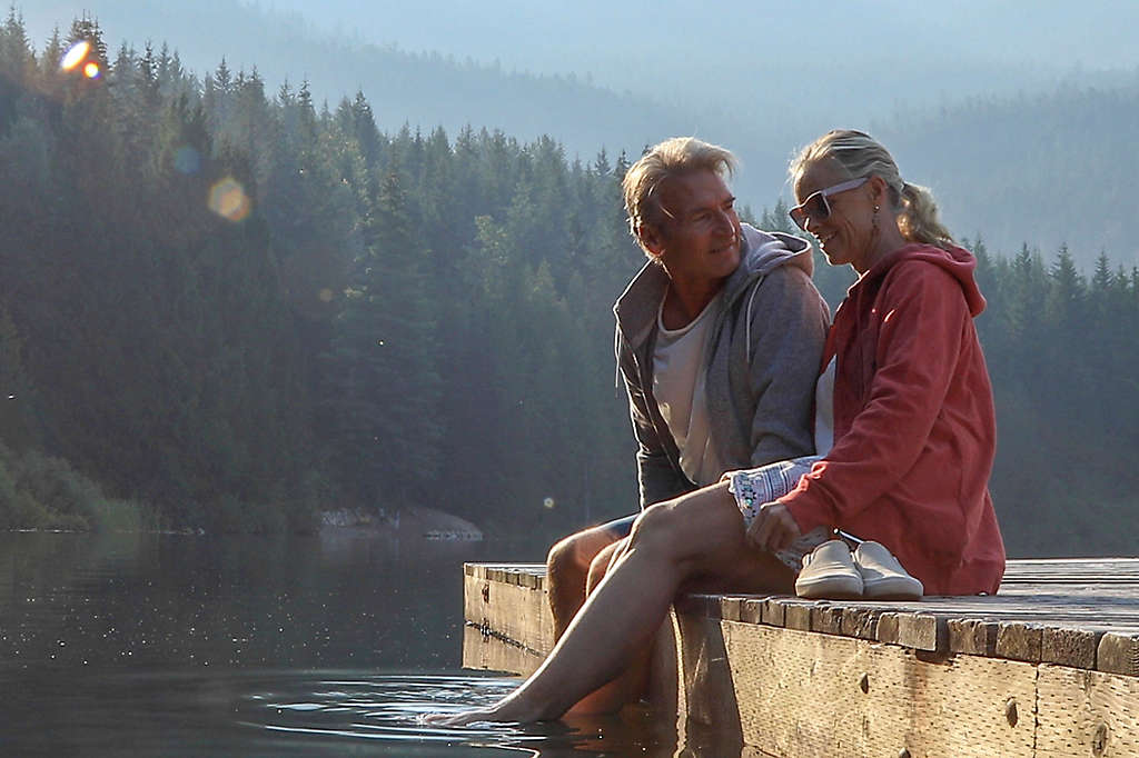 Mature couple spending time together at a lake.