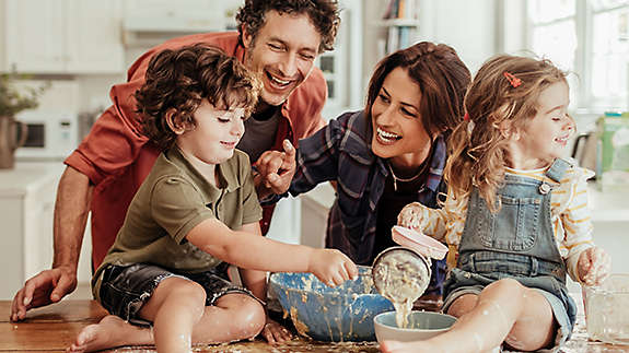 Young family cooking together in their kitchen.