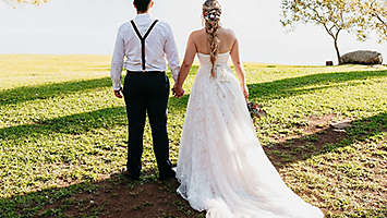 Couple standing outside on their wedding day.