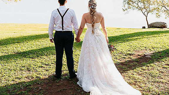 Couple standing outside on their wedding day.