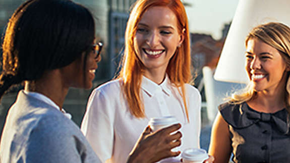 A group of employees talking at the office.