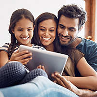 Young family sitting on their couch.