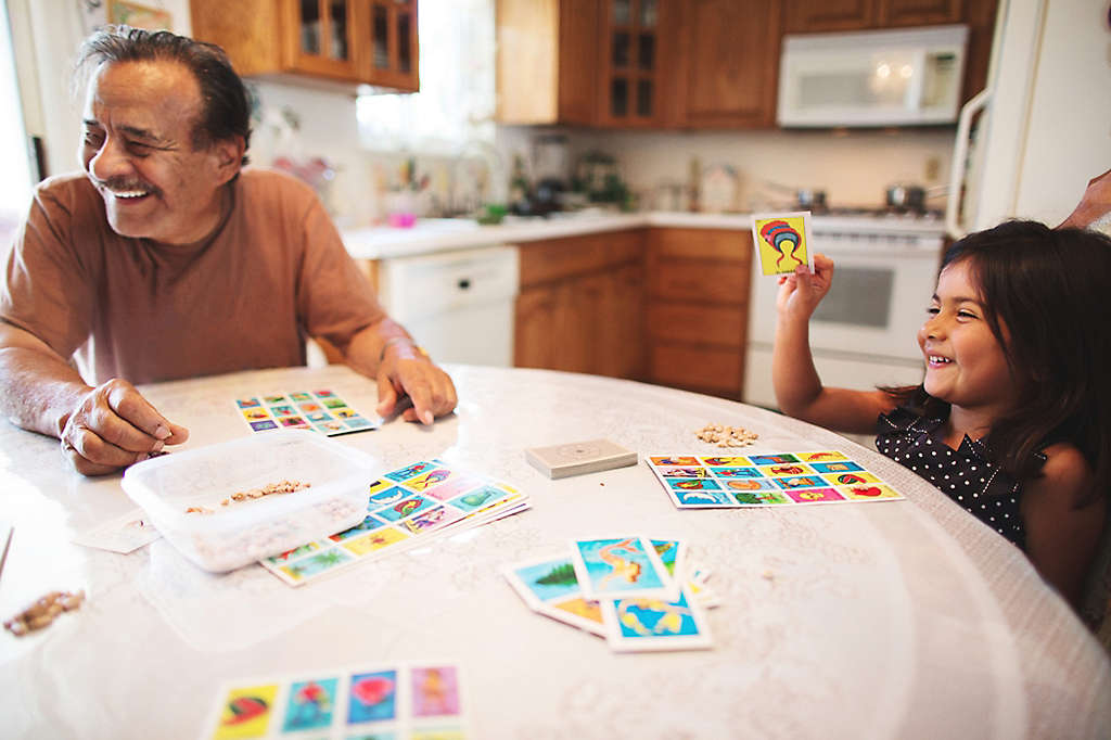 Grandpa and granddaughter play a board game