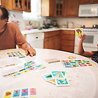 Grandpa and granddaughter play a board game