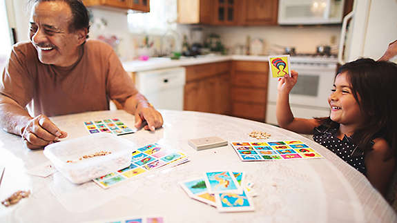 Grandpa and granddaughter play a board game