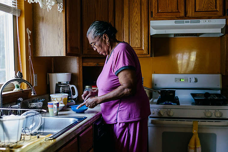 Elderly women in kitchen cooking