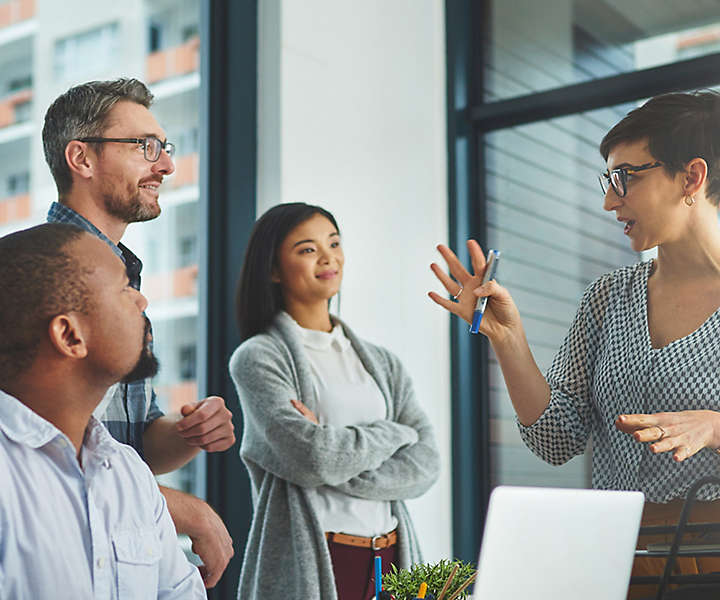 Colleagues having friendly discussion in office