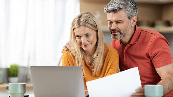 A couple reviewing their finances on a laptop