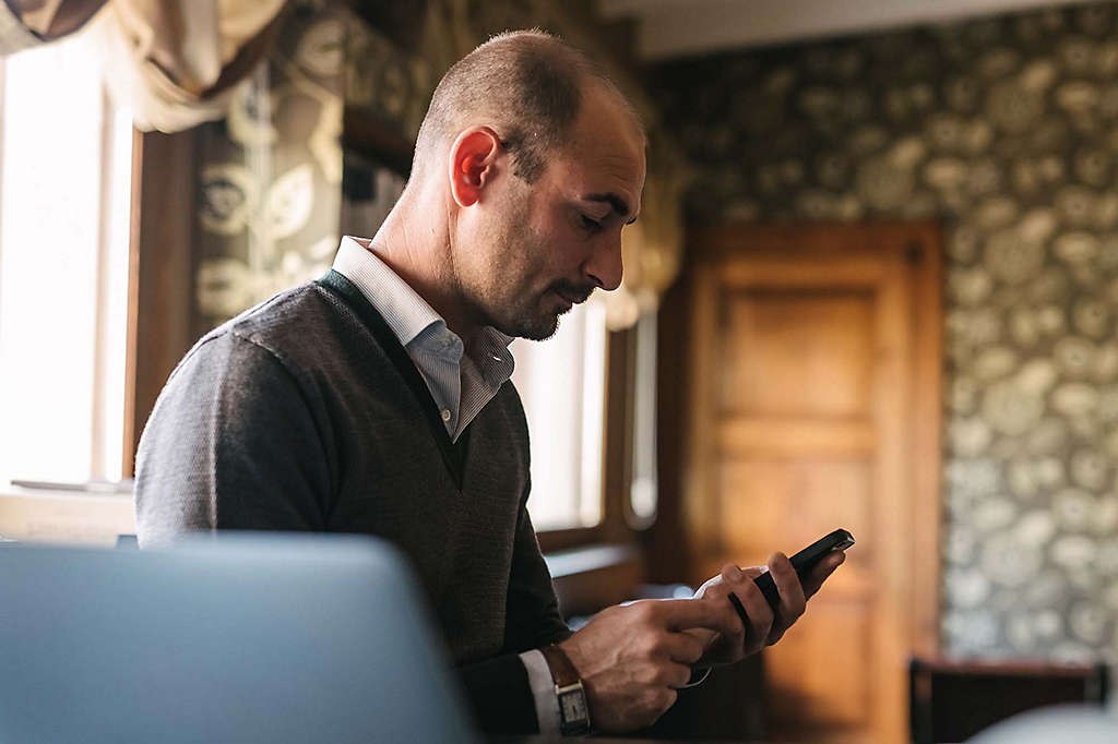 Man reading on cellphone.