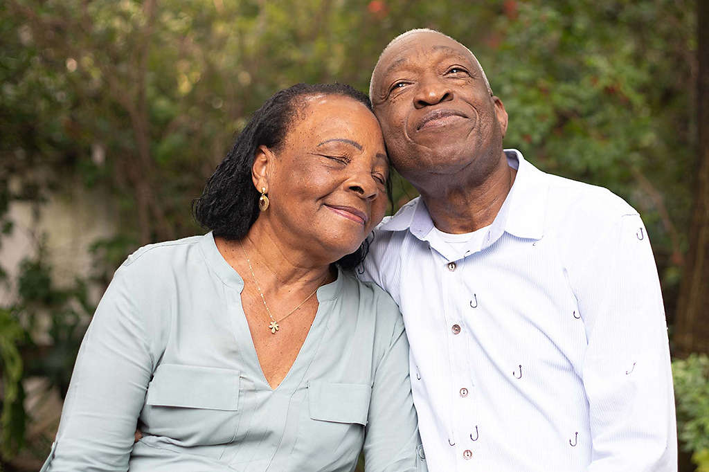 Older couple hugging and enjoying nature.