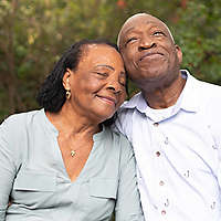 Older couple hugging and enjoying nature.