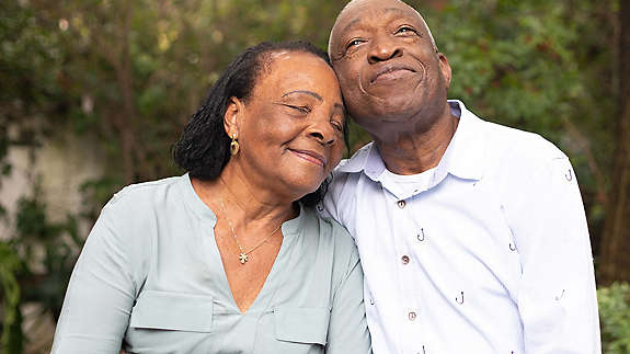 Senior couple sitting together smiling 