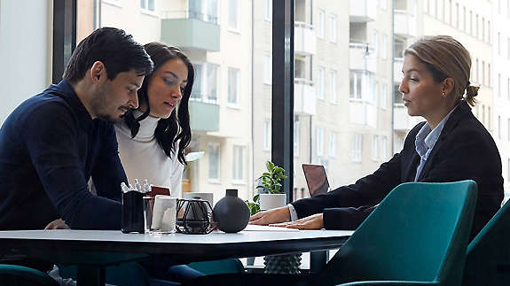 Young couple sitting with agent 