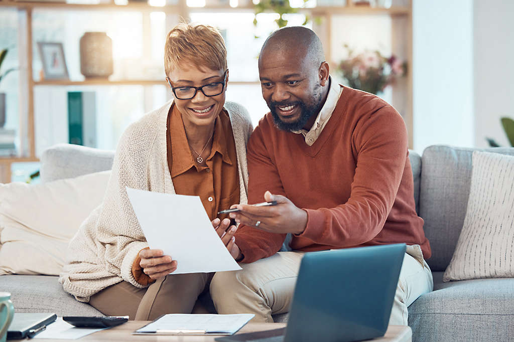 Two people smiling and shaking hands