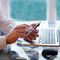 Man sitting at work desk on the phone