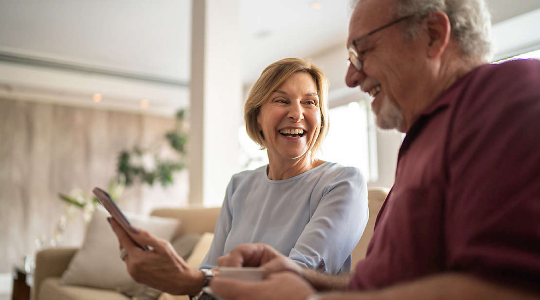 Senior couple and smiling with phone