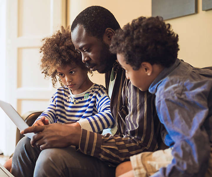 Father reading to his two children.