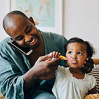 Dad brushing daughters teeth