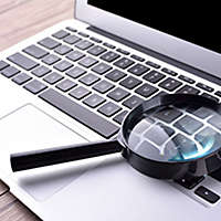 computer and magnifying glass