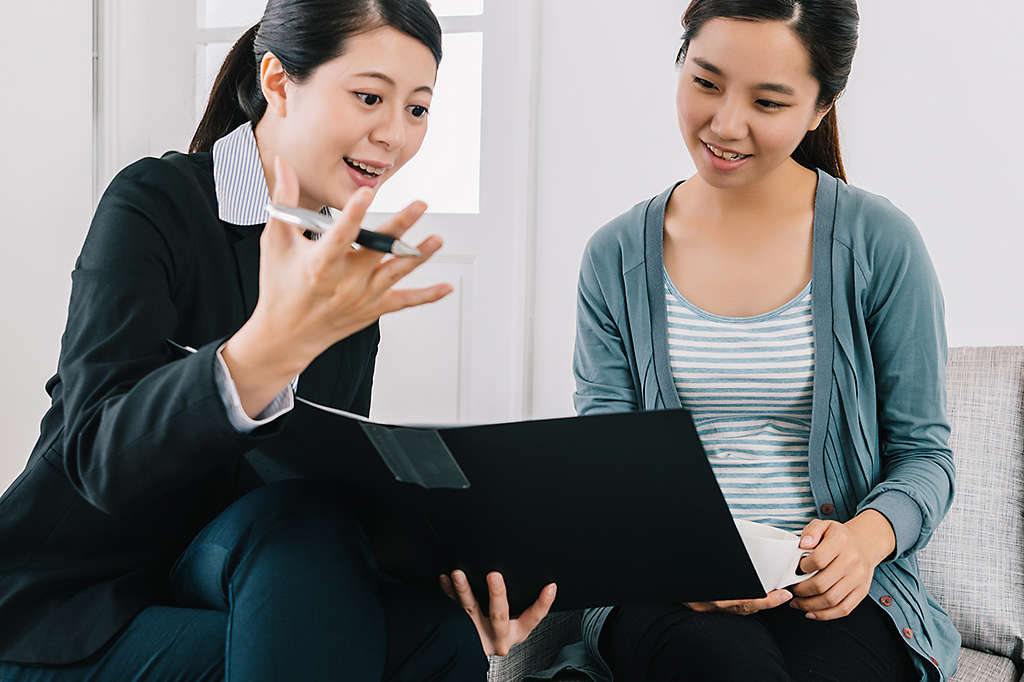 Chinese women going over portfolio