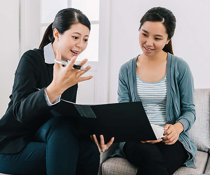 Chinese women going over portfolio