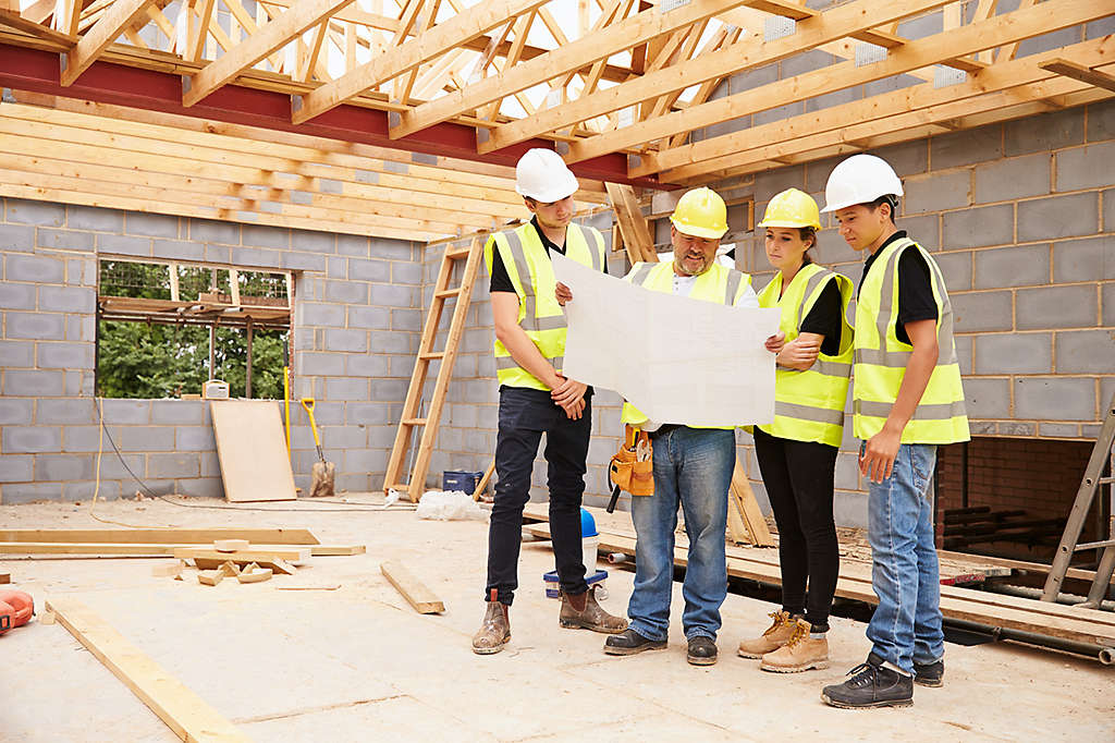 Construction crew reading blueprint