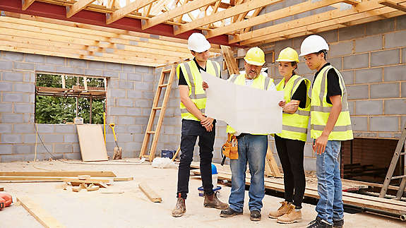 Construction crew reading blueprint