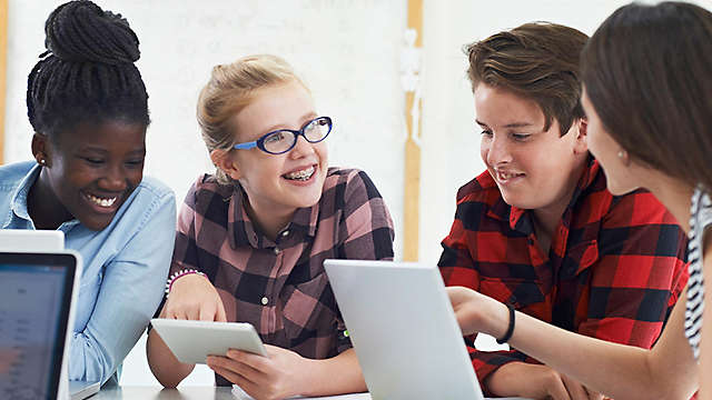 Diverse group of students working at desk